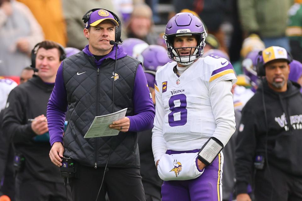 Kirk Cousins #8 of the Minnesota Vikings talks with head coach Kevin O'Connell during the third quarter against the Minnesota Vikings at Lambeau Field on October 29, 2023 in Green Bay, Wisconsin.