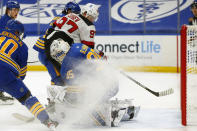 Buffalo Sabres goalie Linus Ullmark (35) stops New Jersey Devils forward Nikita Gusev (97) during the first period of an NHL hockey game Saturday, Jan. 30, 2021, in Buffalo, N.Y. (AP Photo/Jeffrey T. Barnes)