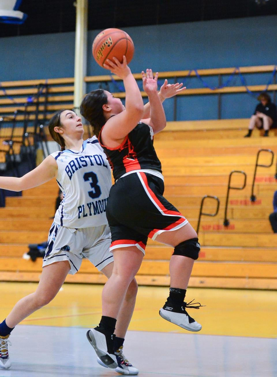 Diman’s Hannah Martin takes a shot past Bristol-Plymouth’s Gianna Viola in a game earlier this year.