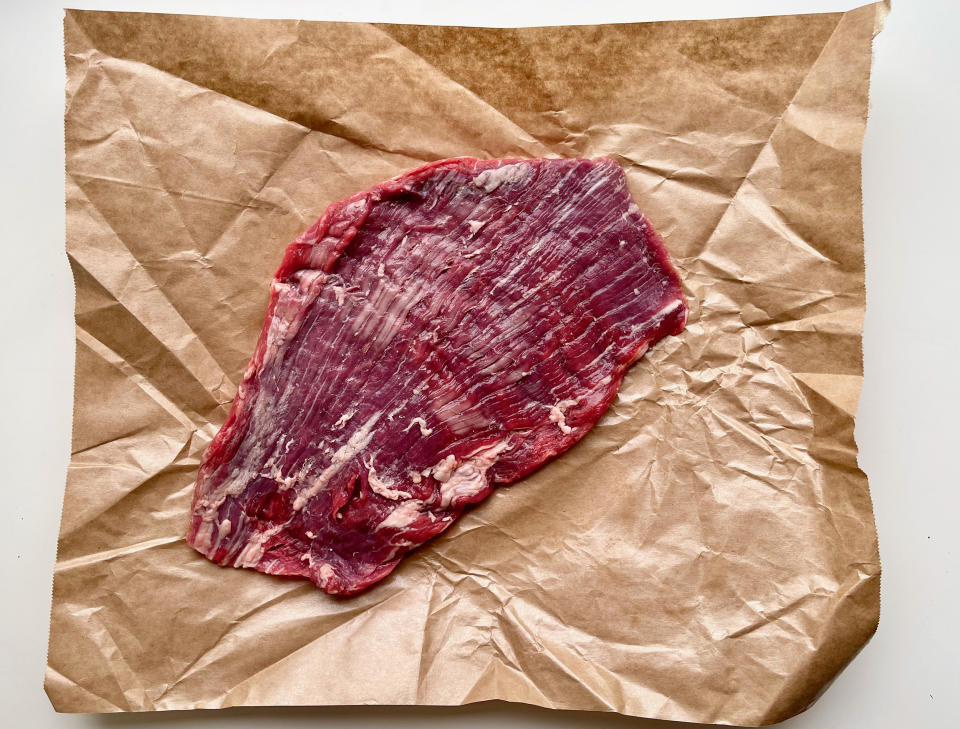 Try to find a flank steak that is as evenly sized as possible so that it cooks as evenly as possible. (Ali Rosen)