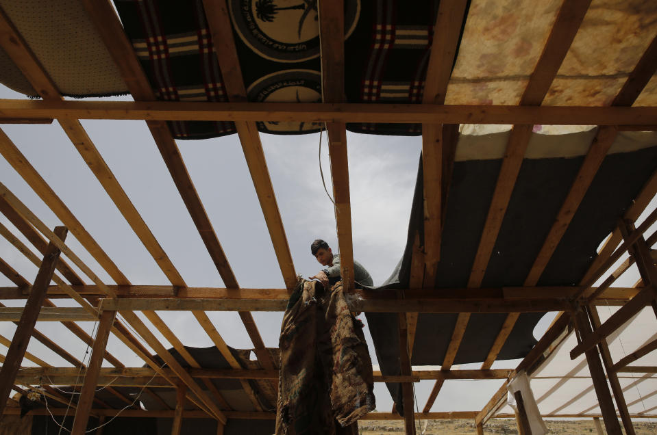 A Syrian man removes cloth from his makeshift shelter, as he prepares to evacuate an informal refugee camp after a fight broke out last week between camp residents and Lebanese firefighters who arrived to put out a fire, in Deir Al-Ahmar, east Lebanon, Sunday, June 9, 2019. Dozens of Syrian refugees have dismantled their tents in a camp they lived in for years in eastern Lebanon after authorities ordered their evacuation following a brawl with locals. Lebanon hosts over 1 million Syrian refugees who fled the war next door since 2011, overwhelming the country of nearly 5 million. (AP Photo/Hussein Malla)