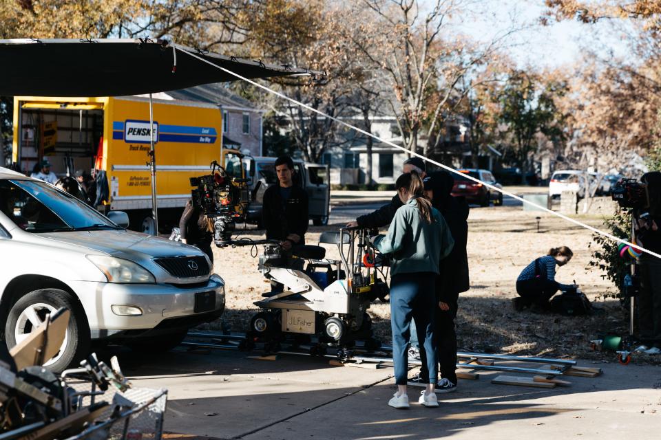 "The Book of Jobs" production crew prepares to film an scene in the driveway of a Bartlesville home recently.