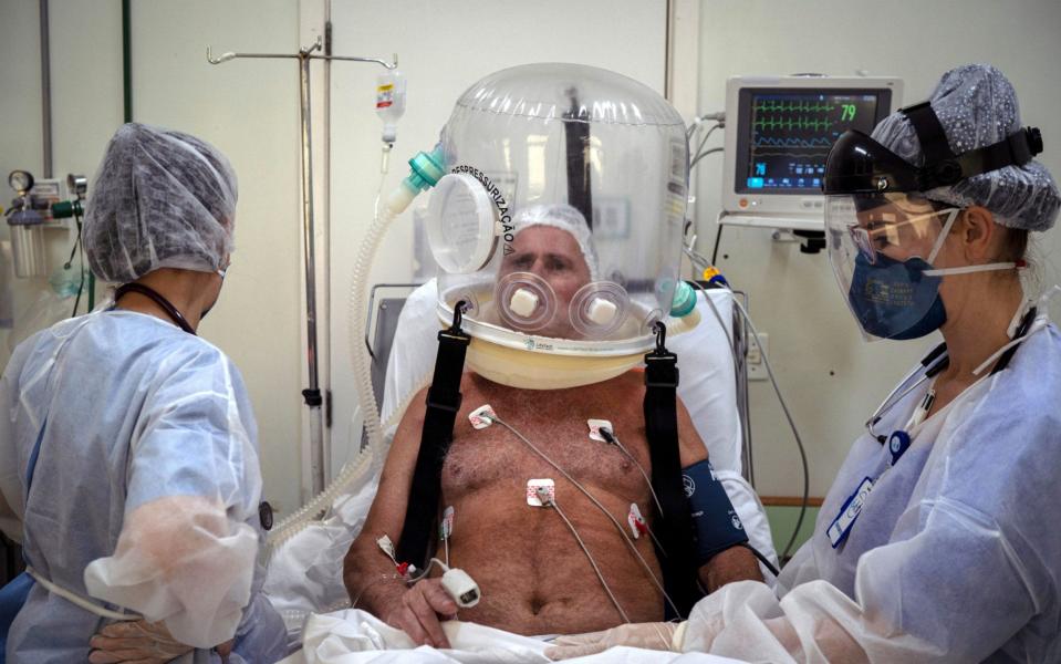 Health workers treat a Covid-19 patient with a bubble helmet in Sao Leopoldo, Brazil - Daniel Marenco/EPA-EFE/Shutterstock