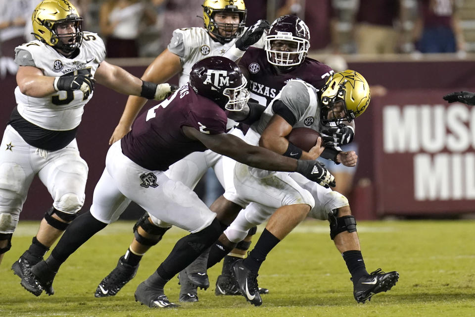 Vanderbilt quarterback Ken Seals, right, is sacked by Texas A&M's Micheal Clemons (2) McKinnley Jackson during the second half of an NCAA college football game Saturday, Sept. 26, 2020, in College Station, Texas. Texas A&M won 17-12. (AP Photo/David J. Phillip)