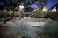 Enrique Silva, Department of Water and Power (DWP) Water Conservation Response Unit supervisor, patrols the streets looking for people wasting water during the drought in Los Angeles, California, April 17, 2015. REUTERS/Lucy Nicholson