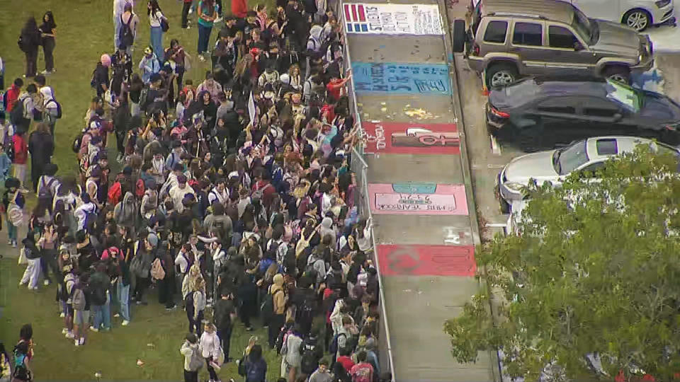 Students at at Monarch High School in Coconut Creek walked out of class around noon Tuesday to protest the reassignment of Principal James Cecil and staffers. (NBC South Florida)