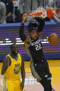 Sacramento Kings forward Richaun Holmes (22) dunks in front of Golden State Warriors forward Draymond Green (23) during the first half of an NBA basketball game in San Francisco, Monday, Jan. 4, 2021. (AP Photo/Jeff Chiu)