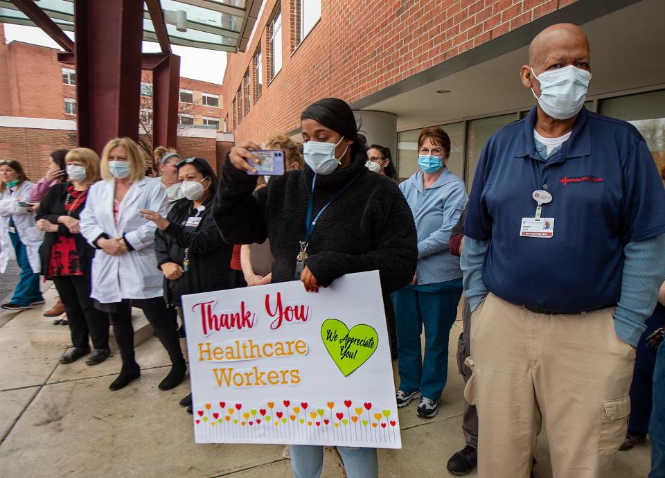 Lower Bucks Hospital nurses and staff gather outside to listen to the Harry S. Truman High School Marching Band perform Thursday, March 24, 2022, during a ceremony marking the two-year anniversary of the hospital's first COVID patient.