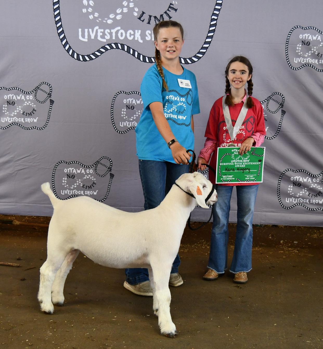 Kara Kingery, right, entered a goat with the help of her mentor Caitlynn Noble, in the Ottawa County No Limit Livestock Show on Saturday.