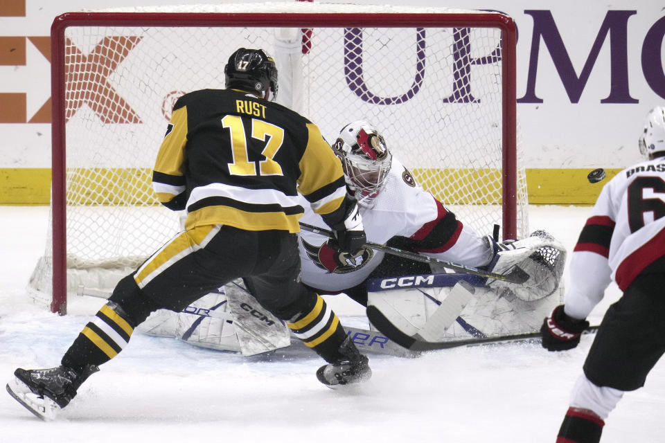 Pittsburgh Penguins' Bryan Rust (17) can't get a shot past Ottawa Senators goaltender Dylan Ferguson (34) during the first period of an NHL hockey game in Pittsburgh, Monday, March 20, 2023. (AP Photo/Gene J. Puskar)