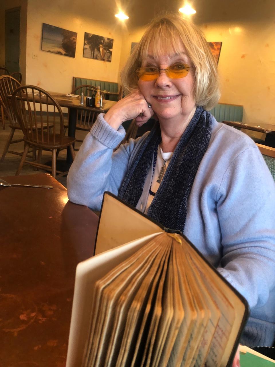 Kendra Kersey holds one of the diaries her mother Evelyn Gray Sprague kept between 1942 and 1962. Kersey is planning to write a book titled "In My Mother's Handwriting" based on the diaries.