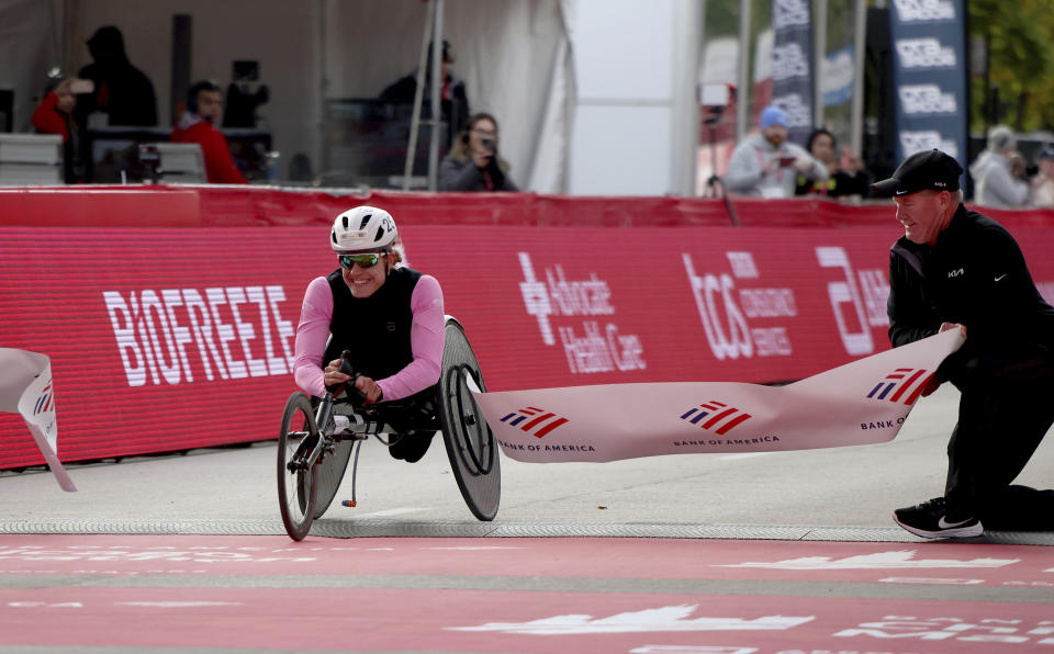 Catherine Debrunner (SUI) celebrates her Chicago Marathon course record victory, in Chicago's Grant Park on Sunday, Oct. 8, 2023. (Eileen T. Meslar /Chicago Tribune via AP)