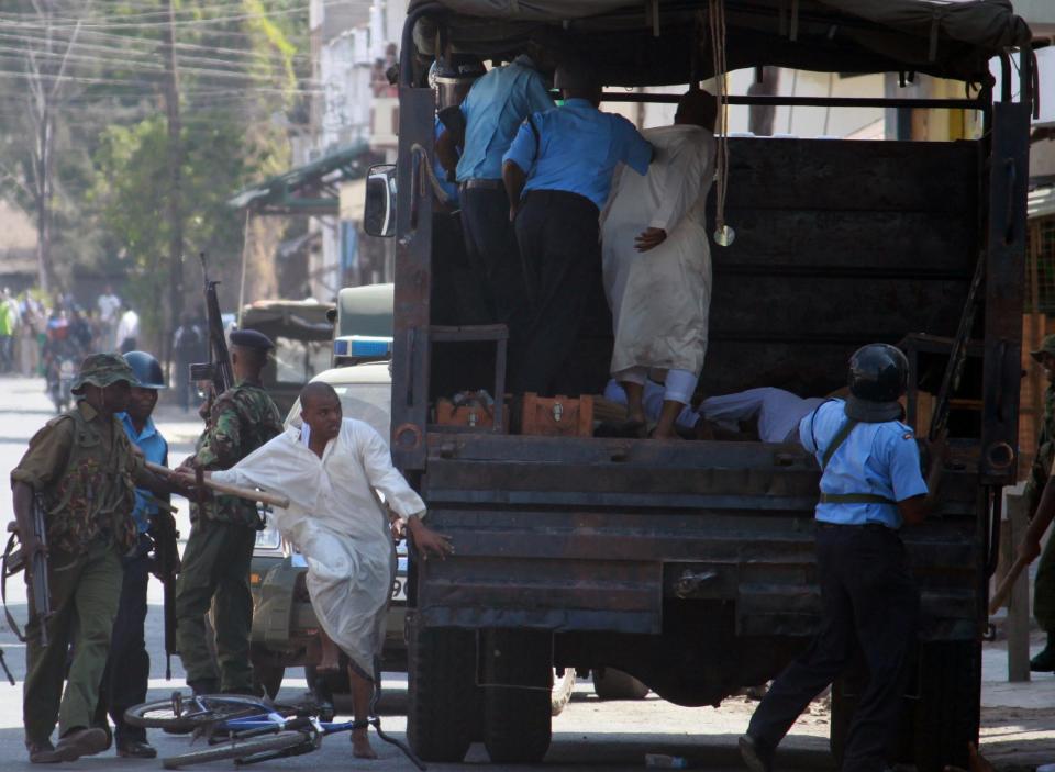 Kenyan anti riot police officers detain Muslim youths outside Masjid Musa in majengo, Mombasa, Sunday, Feb. 2, 2014. A riot outside a mosque in Kenya’s coastal resort and port city of Mombasa has left at least one police officer injured. (AP Photo)