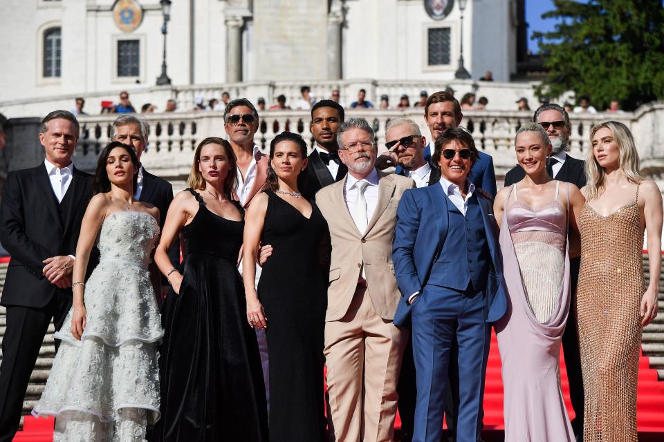 (From L back row) British actor Cary Elwes, Canadian actor Henry Czerny, US actor Esai Morales, US actor Greg Tarzan Davis, British actor Simon Pegg, British actor Frederick Schmidt, US actor Shea Whigham (from L first row) Cuban, Italian and US actress Mariela Garriga, Swedish actress Rebecca Ferguson, British-US actress Hayley Atwell, US film director Christopher McQuarrie, US producer and actor Tom Cruise, French actress Pom Klementieff and British actress Vanessa Kirby pose on the Spanish Steps ahead of the premiere of “Mission: Impossible – Dead Reckoning Part One” movie in Rome, on June 19, 2023. (Photo by Tiziana FABI / AFP) (Photo by TIZIANA FABI/AFP via Getty Images)