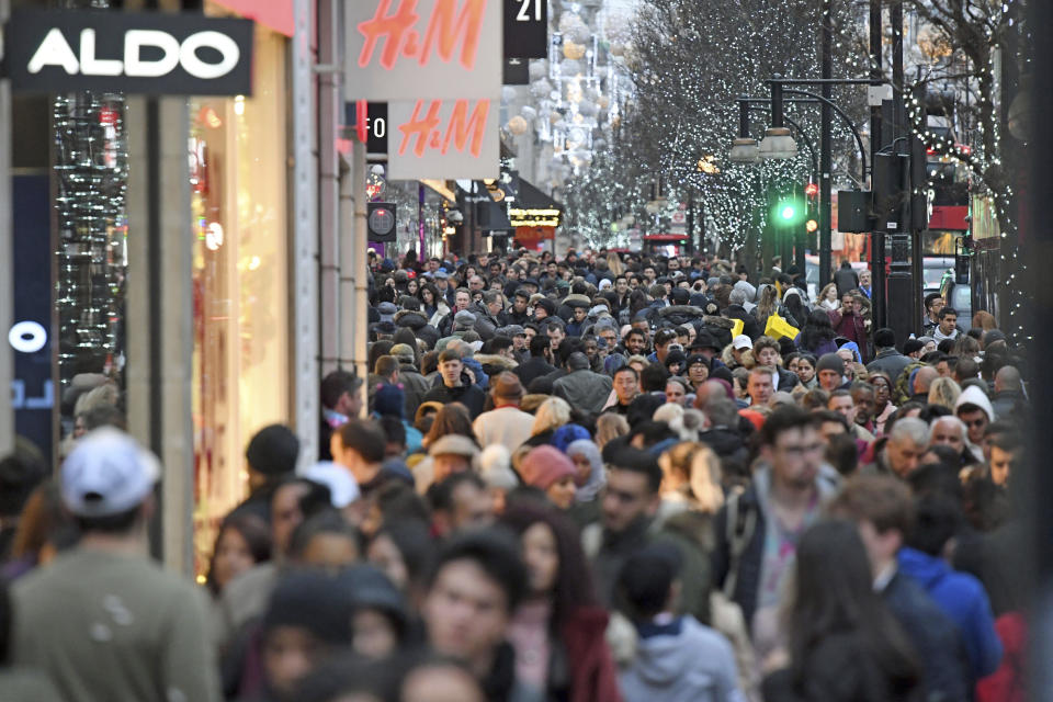 Shoppers crowd onto Oxford street on the last day of Christmas shopping, in London, Sunday, Dec. 24, 2017. (Victoria Jones/PA via AP)