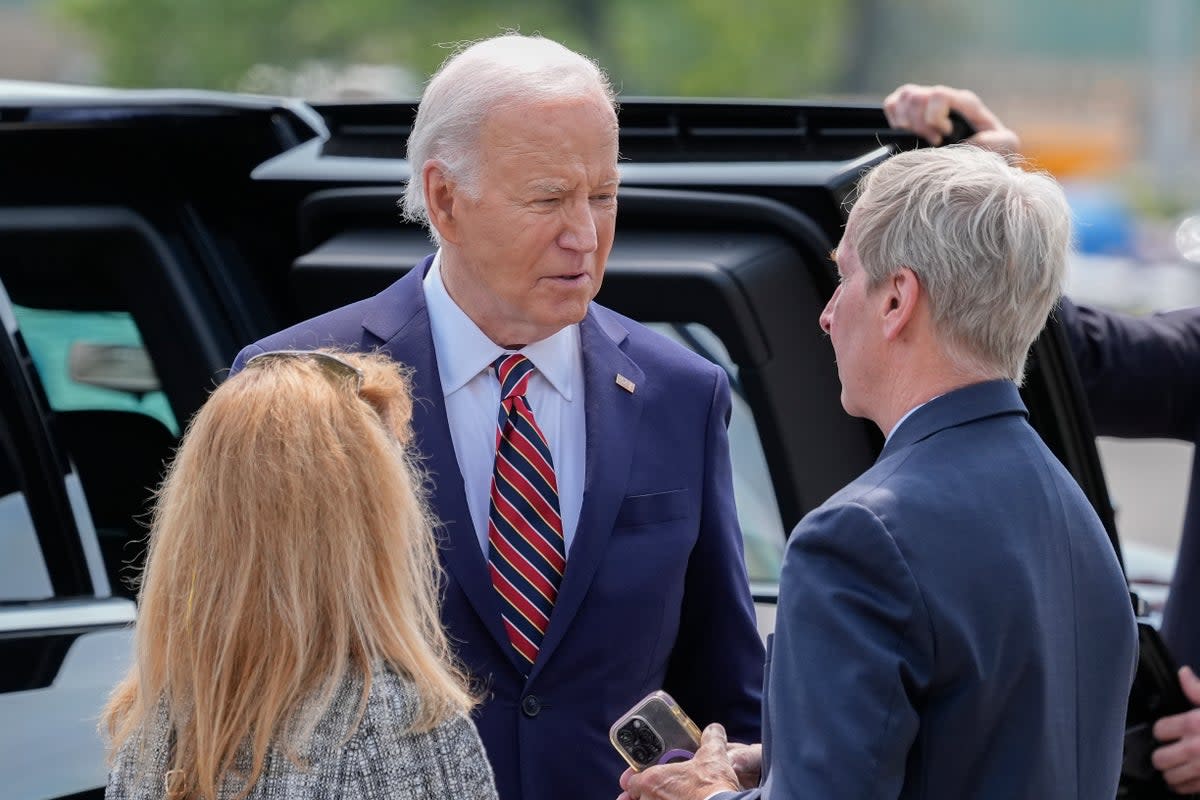 President Joe Biden, center, talks with John Lynch, former Governor of New Hampshire, right, and Lynch's spouse Dr. Susan Lynch, left, on the tarmac during Air Force One arrival at Manchester-Boston Regional Airport, Tuesday, May 21, 2024, in Manchester, N.H. (AP Photo/Alex Brandon) (AP)