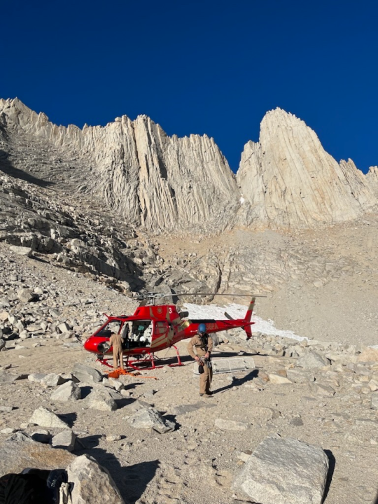 A National Park Service ranger attaches rigging for a helicopter short haul. (NPS Photo)