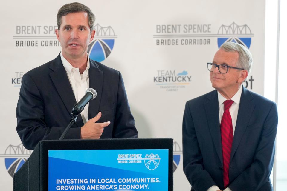 Kentucky and Ohio governors Andy Beshear (left) and Mike Dewine take questions during a press conference to announce updates on the Brent Spence Bridge Corridor project at Devou Park in Covington, Ky., on Thursday, July 27, 2023. Ohio Gov. Mike DeWine and Kentucky Gov. Andy Beshear announced Walsh Kokosing has been awarded the design-build contract for the $3.6 Billion Brent Spence Bridge project.