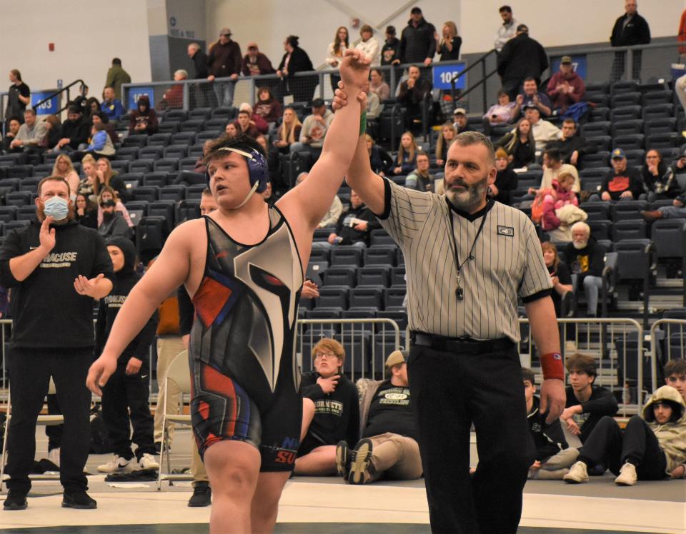 The referee raises the left hand of New Hartford Spartan Chris Belmonte (left), signaling the unbeaten freshman as Section III's Division I champion at 285 pounds Saturday at SRC Arena.