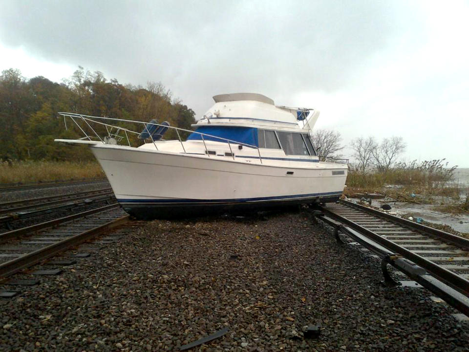 This photo provided by the Metropolitan Transportation Authority of the State of New York shows a boat resting on the tracks at Metro-North's Ossining Station in the aftermath of Hurricane Sandy on Tuesday, Oct. 30, 2012, in Ossining,N.Y. Travel in the Northeast creaked back into motion on Wednesday, Oct., 31, 2012, a grinding, patchy recovery that made it clear that stranded travelers will struggle to get around for days to come. (AP Photo/Metropolitan Transportation Authority of the State of New York) MANDATORY CREDIT