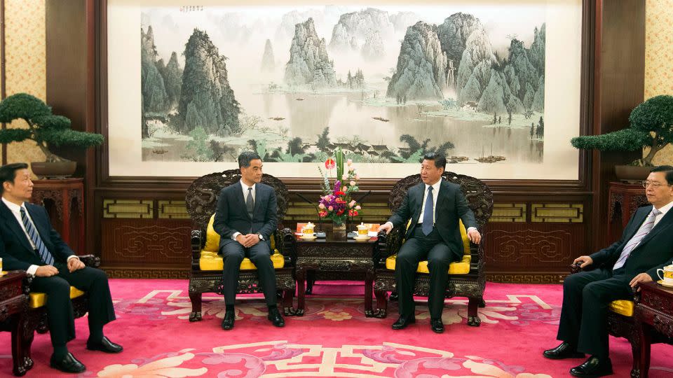 A meeting with former Hong Kong Chief Executive Leung Chun-ying and Chinese leader Xi Jinping in Zhongnanhai on December 26, 2014, a large landscape painting in the background. - Simon Song/South China Morning Post/Getty Images