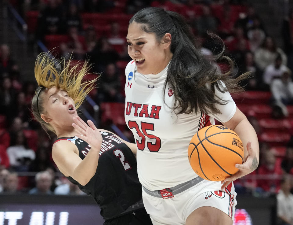 FILE - Utah forward Alissa Pili (35) drives as Gardner-Webb guard Lauren Bevis (2) falls while defending during the first half of a first-round college basketball game in the women's NCAA Tournament, March 17, 2023, in Salt Lake City. The defending Pac-12 co-champion Utes return all five starters, led by league player of the year in her final season. They will get a couple of early tests: against No. 19 Baylor on Nov. 14, 2023, and playing No. 6 South Carolina on a neutral court Dec. 10, 2023. ( AP Photo/Rick Bowmer, File)