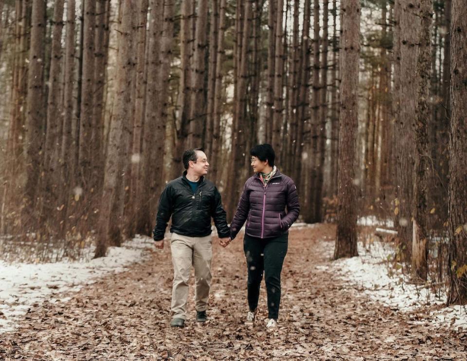 Yuan Thompson, right, and her husband, Chris Thompson, left, of Ottawa, have been together since 2008.  (Submitted by Yuan Thompson - image credit)