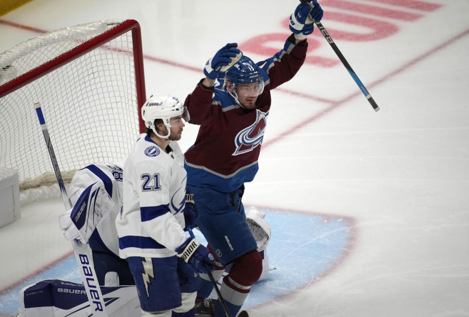 Colorado Avalanche right wing Valeri Nichushkin, back right, reacts after scoring a goal past Tampa Bay Lightning goaltender Andrei Vasilevskiy, back left, as center Brayden Point looks on in the first period of an NHL hockey game Tuesday, Feb. 14, 2023, in Denver. (AP Photo/David Zalubowski)