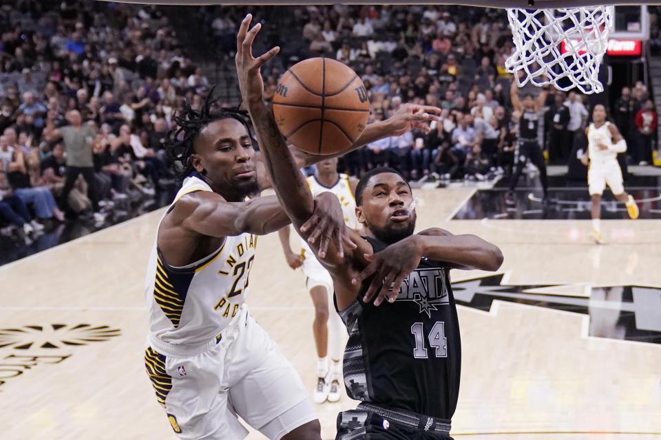 San Antonio Spurs guard Blake Wesley (14) is fouled by Indiana Pacers forward Aaron Nesmith (23) during the first half of an NBA basketball game in San Antonio, Sunday, March 3, 2024. (AP Photo/Eric Gay)