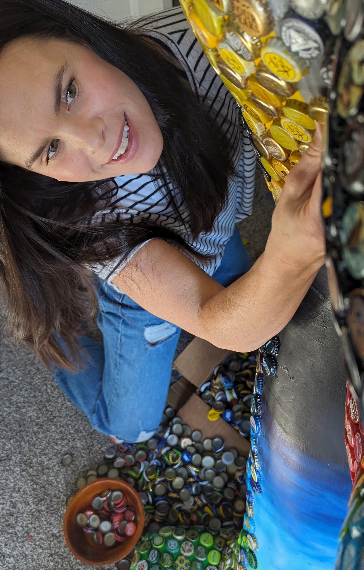 Stacey Jackson of Coralville will have attached some 2,000 color-coded bottle caps to this Herky on Parade statue when completed. She is one of 74 local and regional artists selected to prepare a total of 100 artistically unique Herkys for public display this spring.