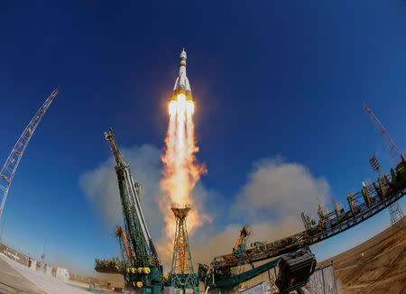 FILE PHOTO: The Soyuz MS-10 spacecraft carrying the crew of astronaut Nick Hague of the U.S. and cosmonaut Alexey Ovchinin of Russia blasts off to the International Space Station (ISS) from the launchpad at the Baikonur Cosmodrome, Kazakhstan October 11, 2018. REUTERS/Shamil Zhumatov/File Photo