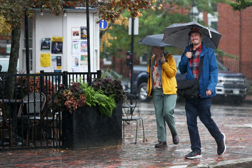 Umbrellas are put to good use in Portsmouth Thursday, Sept. 22, 2022.