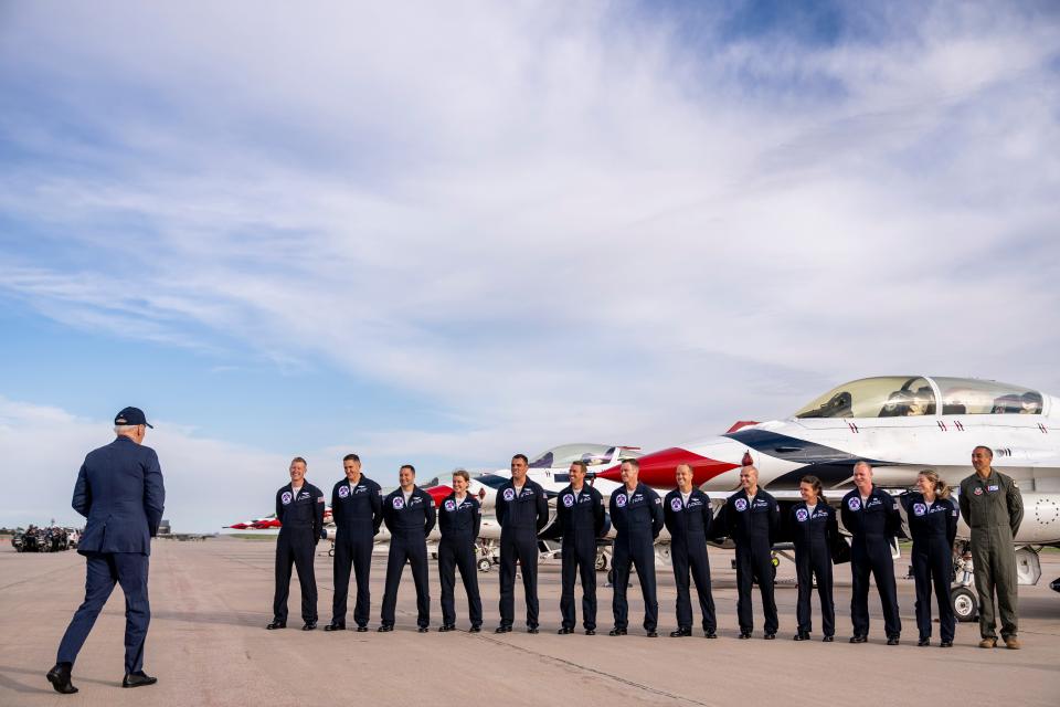 President Joe Biden greats a group of Thunderbird pilots after arriving at Peterson Space Force Base in Colorado Springs, Colo., Wednesday, May 31, 2023. Biden has decided to keep U.S. Space Command headquarters in Colorado, overturning a last-ditch decision by the Trump administration to move it to Alabama and ending months of politically fueled debate.