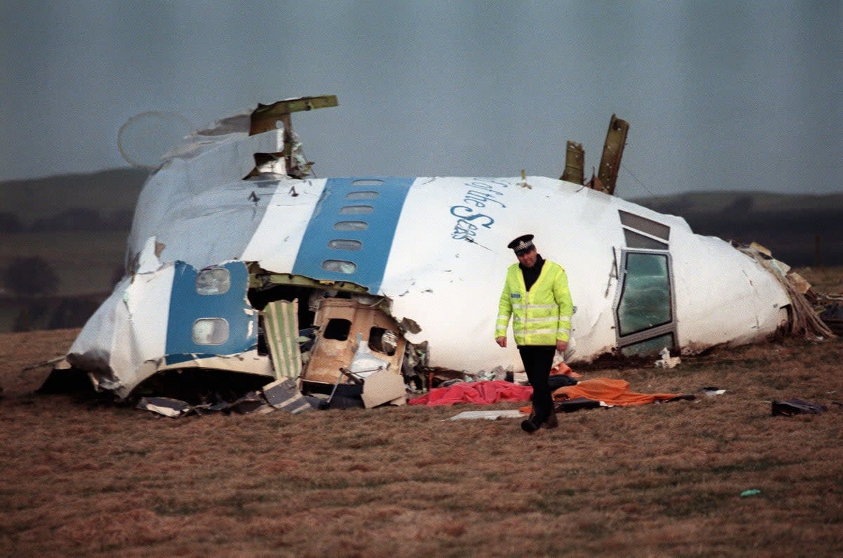 This photo taken on December 22, 1988 shows a policeman walking away from the remains of the 747 Pan Am airliner that exploded and crashed over Lockerbie, Scotland (Getty)