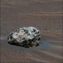 In this image released January 19, 2005, NASA's Mars Exploration Rover "Opportunity": has found an iron meteorite on Mars, the first meteorite of any type ever identified on another planet. The pitted, basketball-size object is mostly made of iron and nickel. This composite combines images taken through the panoramic camera's 600-nanometer (red), 530-nanometer (green), and 480-nanometer (blue) filters REUTERS/NASA/JPL/Cornell/Handout SSM