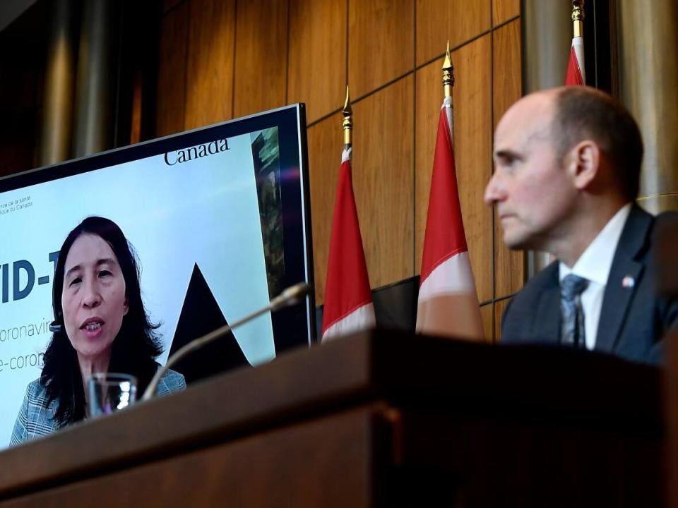 Chief Public Health Officer of Canada Dr. Theresa Tam appears via videoconference as Minister of Health Jean-Yves Duclos looks on during a news conference on the COVID-19 pandemic and the Omicron variant in Ottawa earlier this month. (Justin Tang/The Canadian Press - image credit)