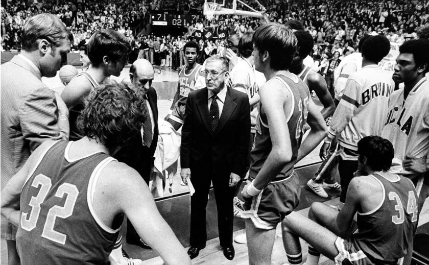UCLA basketball coach John Wooden, center, talks to his players during a time out against Notre Dame.