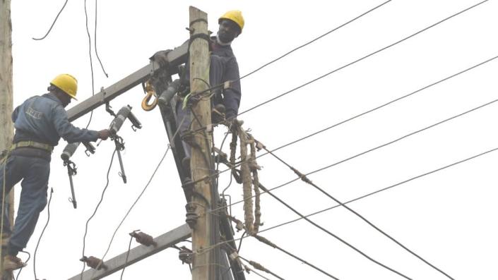 Kenya Power technicians relocating power lines