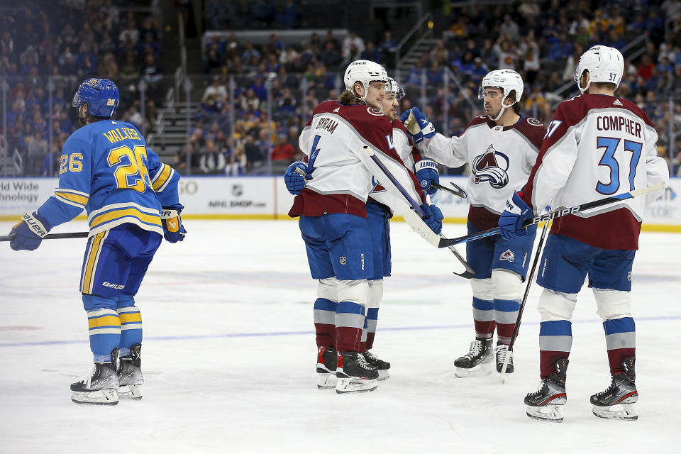 Colorado Avalanche's Bowen Byram (4) is congratulated by teammates after scoring a goal against the St. Louis Blues during the third period of an NHL hockey game Saturday, Feb. 18, 2023, in St. Louis. (AP Photo/Scott Kane)