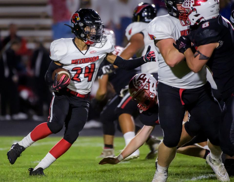 Metamora's Mark Frederick tries to find a hole in the Pekin defense in the second half Friday, Sept. 30, 2022 in Pekin. The Dragons rolled over the Redbirds 55-13.