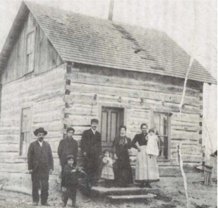 An Indian Village log cabin is seen before the 1900 burnout.