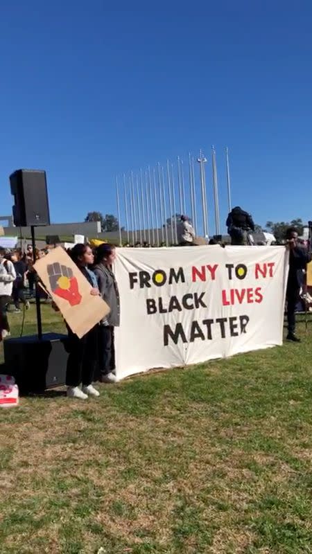 Demonstrators hold a placard during a Black Lives Matter protest in Canberra