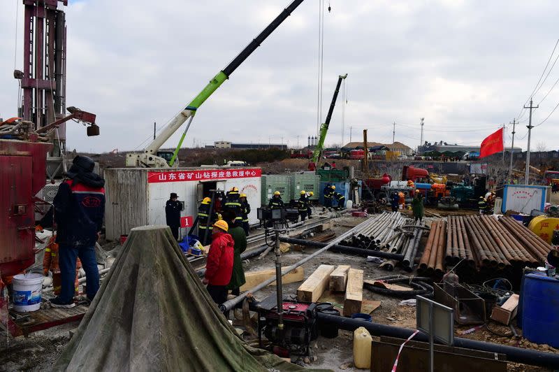 Rescuers work on saving workers trapped underground after an explosion at the Hushan gold mine in Qixia