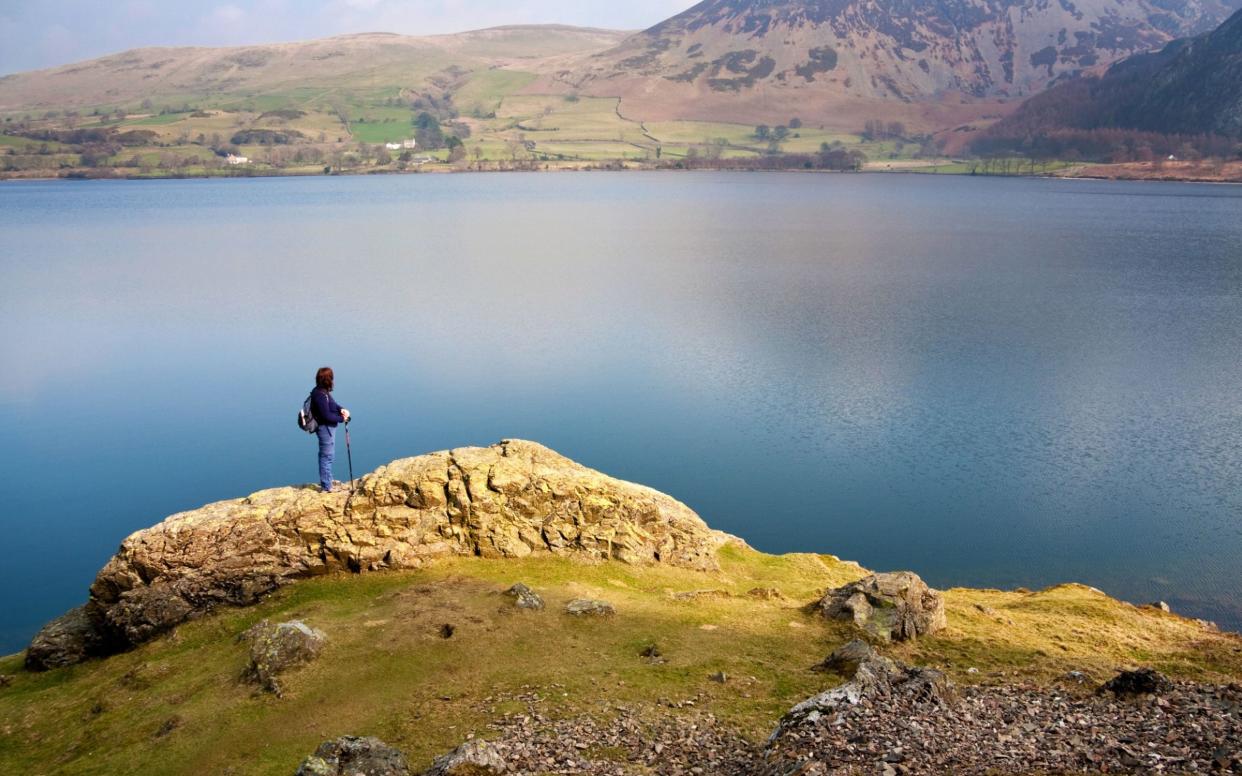 a walker looking at Ennerdale water in the English Lake district