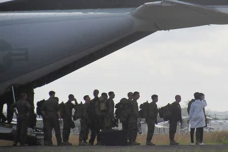 U.S. soldiers have their temperatures taken upon arrival at Roberts International airport outside Monrovia, October 9, 2014. REUTERS/Daniel Flynn