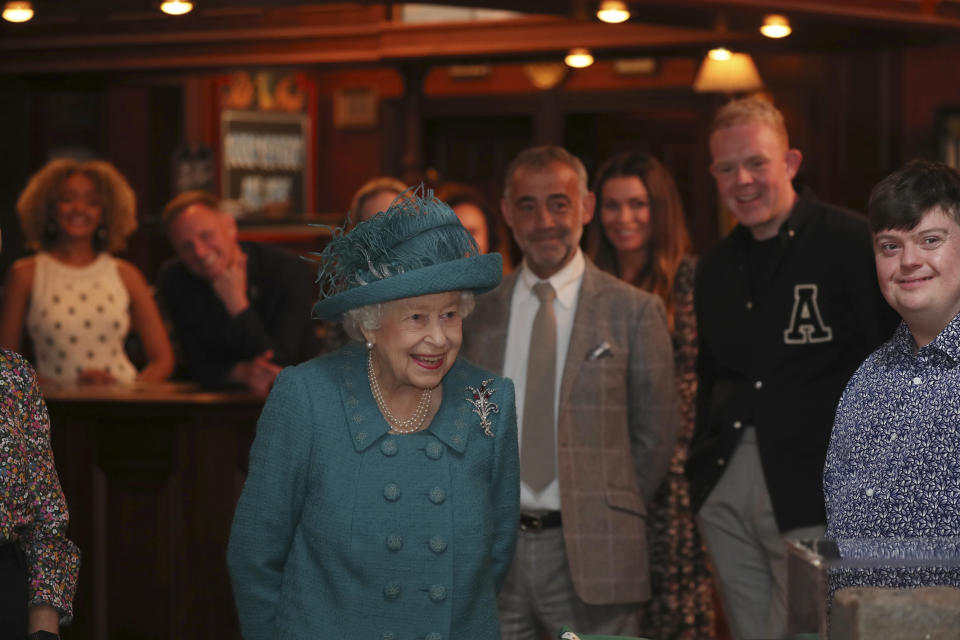 Britain's Queen Elizabeth II meets actors and members of the production team during a visit to the set of the long running television series Coronation Street, in Manchester, England, Thursday July 8, 2021. (AP Photo/Scott Heppell)