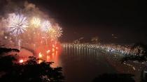 Scores of Brazilians and revelers from around the world ring in the New Year in Rio de Janeiro. Rough Cut (no reporter narration).