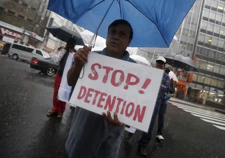 A protester holding a placard shouts slogans at a rally to call for visa grants for asylum seekers in Japan, in central Tokyo, September 9, 2015. REUTERS/Yuya Shino