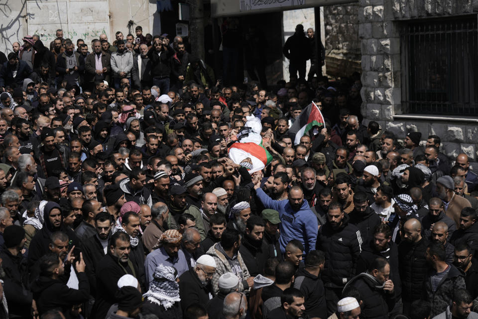 Mourners carry the body of Fakher Bani Jaber, during his funeral in the village of Aqraba, near the West Bank city of Nablus, Wednesday, March 20, 2024. The 40 year-old man was shot and killed on Tuesday by an Israeli settler, according to Palestinian official news agency WAFA. (AP Photo/Majdi Mohammed)