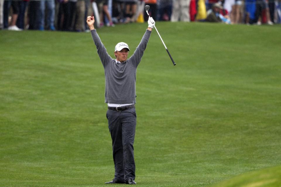 Matt Jones celebrates after chipping in for birdie on a playoff hole against Matt Kuchar to win the Houston Open golf tournament on Sunday, April 6, 2014, in Humble, Texas. (AP Photo/Patric Schneider)